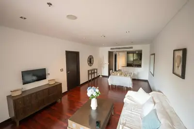 a living room with a couch and a tv at One bedroom appartment Palm Jumeirah in Dubai