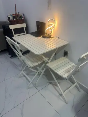 a table and a chair with a light on it at Twin tower in Dubai