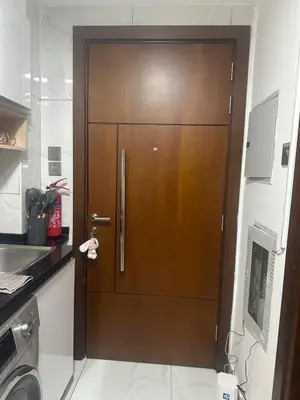 a wooden door in a kitchen next to a sink at Twin tower in Dubai