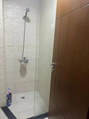 a shower in a bathroom with a glass door at Twin tower in Dubai