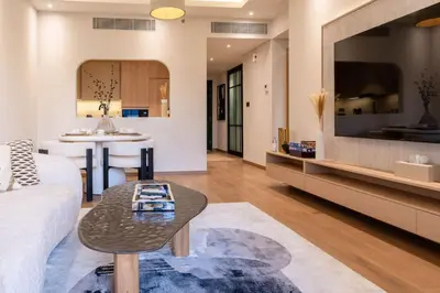 a living room with a couch and a table at 1BR Plus Studio Apartment With Burj View In Downtown Dubai in Dubai