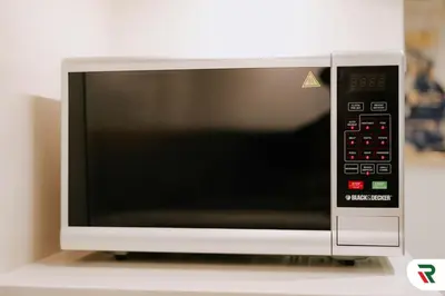 a microwave oven sitting on top of a counter at 2BR Apartment With Lagoon Access In Creek Harbour in Dubai