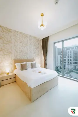 a bedroom with a large bed and a large window at 2BR Apartment With Lagoon Access In Creek Harbour in Dubai