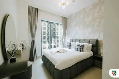 a bedroom with a large bed and a large window at 2BR Apartment With Lagoon Access In Creek Harbour in Dubai