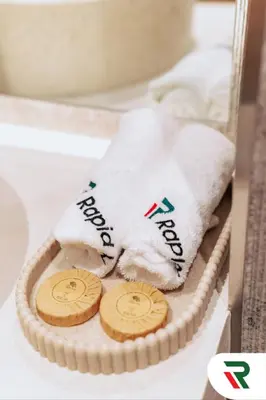 a box with a towel and two cookies in it at 4 Bedroom Burj View Apartment In Downtown Dubai in Dubai