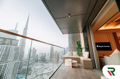 a living room with a view of a city at 4 Bedroom Burj View Apartment In Downtown Dubai in Dubai