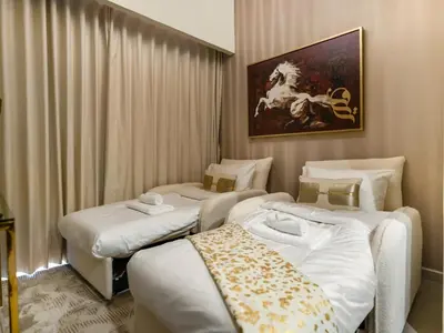 a hotel room with two beds and a painting on the wall at Chic 1BR With Burj Views And Near Dubai Mall in Dubai