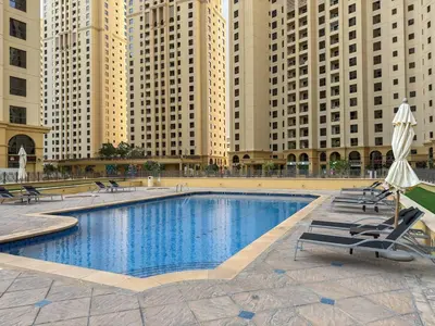a swimming pool in a city with tall buildings at Beachfront JBR Stunning Views, Pool & Gym in Dubai