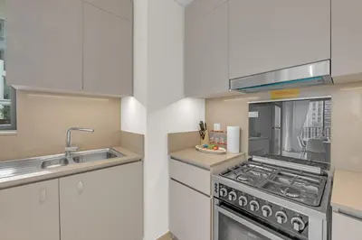 a kitchen with a stove and a sink at Creek Beach Getaway Lagoon, Pool & Gym Access in Dubai