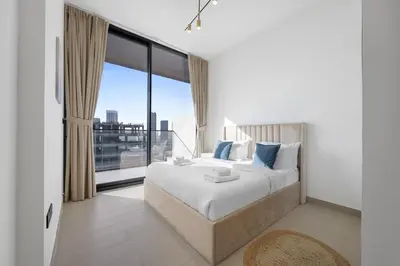 a bedroom with a large bed and a large window at Luxurious JVC Getaway Infinity Pool & Gym in Dubai