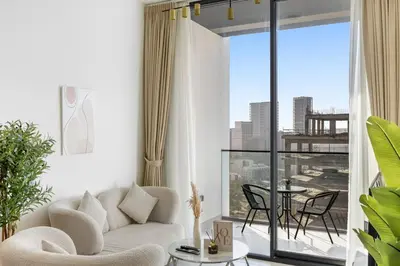 a living room with a couch and a table at Luxurious JVC Getaway Infinity Pool & Gym in Dubai