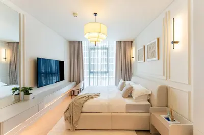 a bedroom with a large bed and a large window at Urban Haven Pool, Gym & Spectacular Views in Dubai