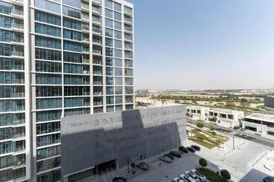 an aerial view of a large building with a parking lot at Urban Haven Pool, Gym & Spectacular Views in Dubai
