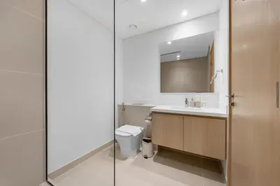 a bathroom with a sink and a toilet and a mirror at Burj Khalifa Views Luxury Stay with Pool & Gym in Dubai