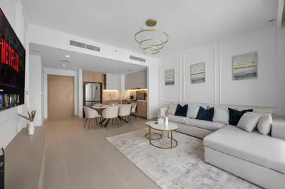 a living room with a couch and a table at Burj Khalifa Views Luxury Stay with Pool & Gym in Dubai