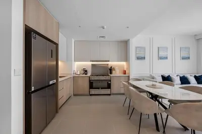 a kitchen and dining room with a table and chairs at Burj Khalifa Views Luxury Stay with Pool & Gym in Dubai