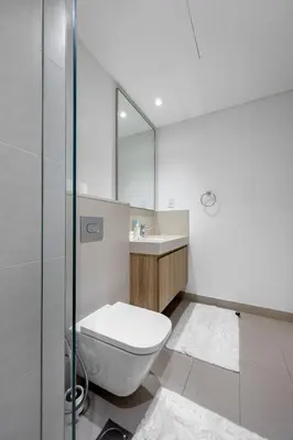 a bathroom with a toilet and a sink and a mirror at Burj Khalifa Views Pool, Gym & Downtown Ease in Dubai