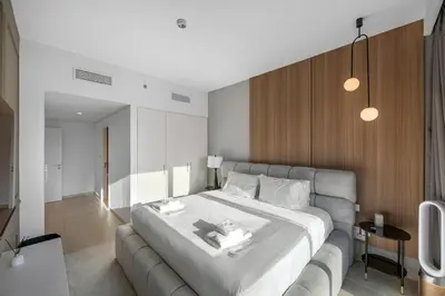 a bedroom with a large bed and a couch at Burj Khalifa Views Pool, Gym & Downtown Ease in Dubai