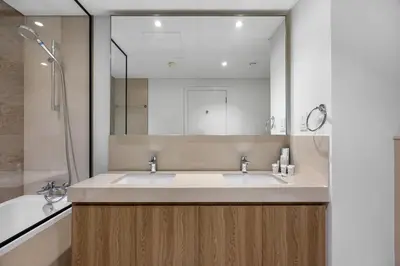 a bathroom with a sink and a large mirror at Burj Khalifa Views Pool, Gym & Downtown Ease in Dubai