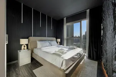 a bedroom with a large bed and a large window at Burj Khalifa Views Pool, Gym & Downtown Ease in Dubai