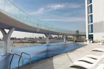 a bridge over a swimming pool on top of a building at 21 Studio in Skyz by Danube, Arjan in Dubai
