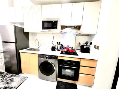 a kitchen with a washing machine and a microwave at 21 Studio in Skyz by Danube, Arjan in Dubai