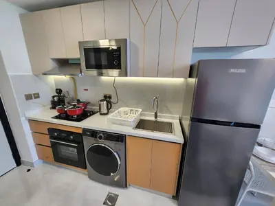 a small kitchen with a sink and a refrigerator at 21 Studio in Skyz by Danube, Arjan in Dubai
