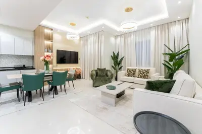 a living room with a couch and a table at Modern 2BR Prime Downtown Location in Dubai