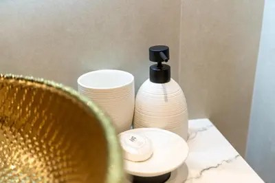 a table with two white plates and a black bottle at Modern 2BR Prime Downtown Location in Dubai