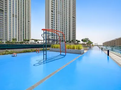 a basketball hoop on top of a pool with tall buildings at Chic & Classic 1BDR In Downtown Views-14 in Dubai
