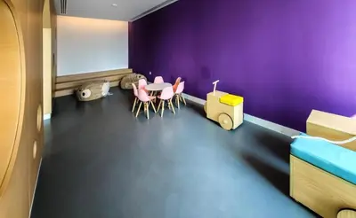 a room with a purple wall and a table and chairs at Chic & Classic 1BDR In Downtown Views-14 in Dubai