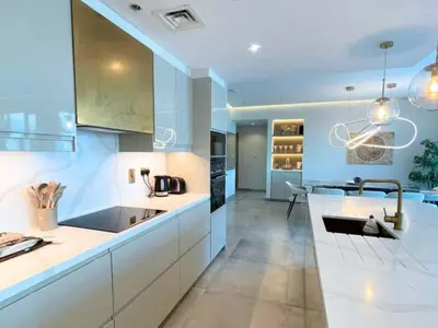 a large kitchen with white cabinets and a sink at Luxury 2 Bedroom Shemara Tower Dubai Marina in Dubai