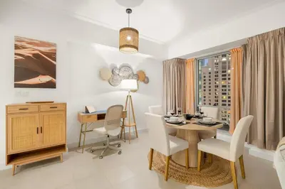 a living room with a table and chairs and a desk at FIRST CLASS 1BR Luxury Marina View Escape in Dubai