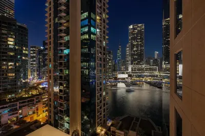 a view of a river in a city at night at FIRST CLASS 1BR Luxury Marina View Escape in Dubai