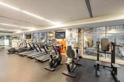a gym with a bunch of tread machines in it at FIRST CLASS 1BR Luxury Marina View Escape in Dubai