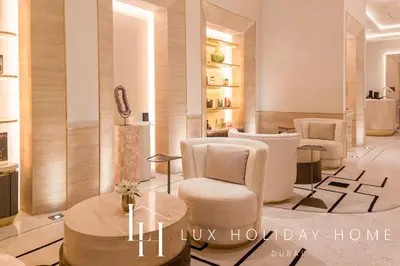 a salon with chairs and a table in a room at LUX Iconic Views at The Palm Tower Suite 8 in Dubai