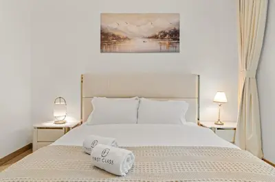 a bedroom with a bed with two towels on it at FIRST CLASS 1BR Luxe Hideaway Escape in Dubai