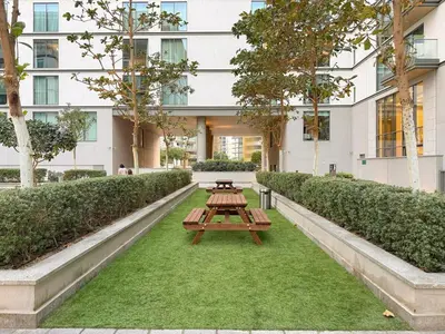 a picnic table in front of a building at FIRST CLASS 1BR Luxe Hideaway Escape in Dubai