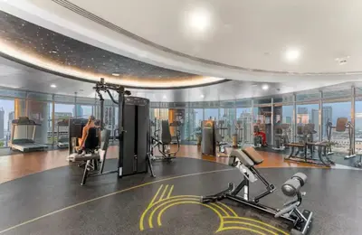 a gym with exercise equipment in a building at have fun with your family and friends in our apt in Dubai