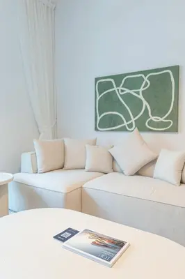 a living room with two couches and a table at PVH - Kensington Waters - Lavish 1BR - Park Front in Dubai