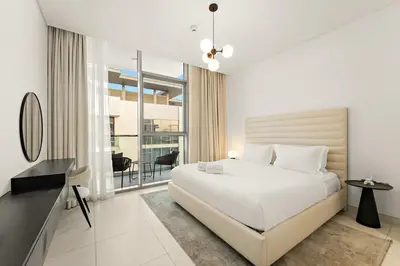 a bedroom with a white bed and a large window at FIRST CLASS 1BR Relaxing Urban Escape in Dubai