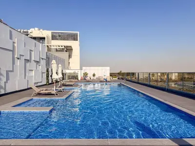 a large swimming pool on the roof of a building at Luxury 2BR w City View Balcony in Dubai