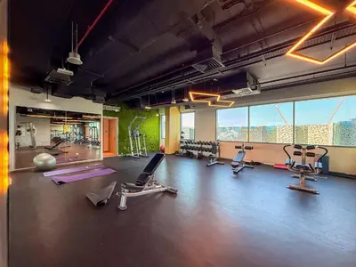 a gym with treadmills and exercise equipment in a building at Luxury 2BR w City View Balcony in Dubai