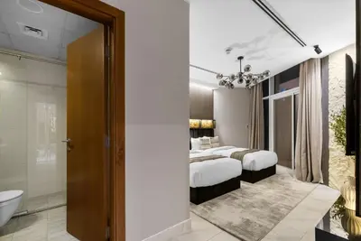 a bedroom with two beds and a bathroom at Gogoto6 2BR Super Premium Canal & Burj Khalifa View in Dubai