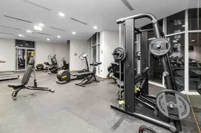 a gym with several treadmills and exercise bikes at Gogoto6 2BR Super Premium Canal & Burj Khalifa View in Dubai
