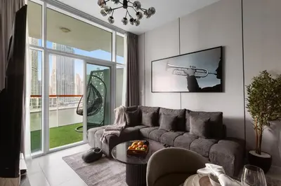 a living room with a couch and a table at Gogoto6 2BR Super Premium Canal & Burj Khalifa View in Dubai