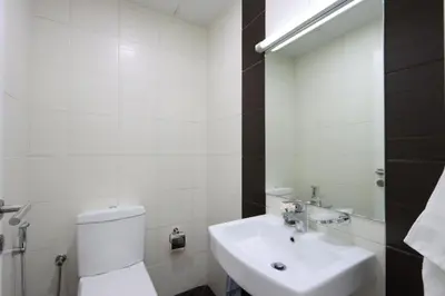 a white bathroom with a toilet and a sink at Prime Located 3B with full Marina Views, Near Beach & Marina Mall in Dubai