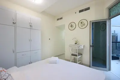 a white bedroom with a bed and a window at Prime Located 3B with full Marina Views, Near Beach & Marina Mall in Dubai