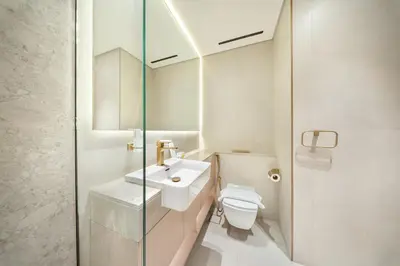 a white bathroom with a sink and a toilet at FIRST CLASS Studio Stylish Near Circle Mall in Dubai