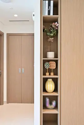 a book shelf with a plant in a room at Luxury 1BR Beach Access Creek Beach in Dubai